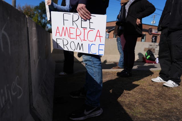 <p>A protester holds a sign outside an ICE processing facility in the Chicago suburb of Broadview, Ill., Tuesday, Oct. 21, 2025</p>