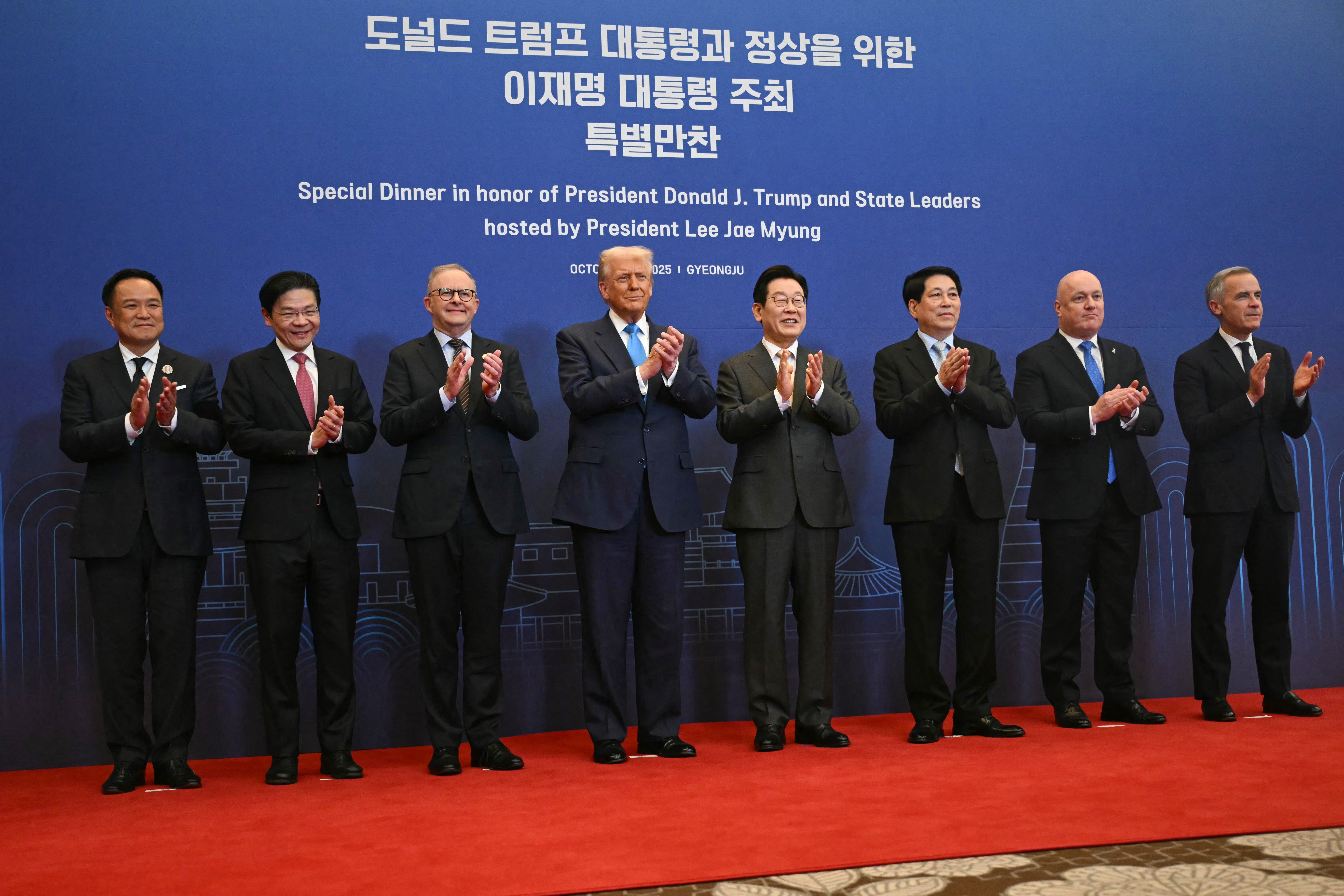 Left to right, Thailand's Prime Minister Anutin Charnvirakul, Singapore's Prime Minister Lawrence Wong, Australia's Prime Minister Anthony Albanese, President Donald Trump, South Korea's President Lee Jae Myung, Vietnam's President Luong Cuong, New Zealand's Prime Minister Christopher Luxon and Canada's Prime Minister Mark Carney pose for a photo upon their arrival for a special dinner at the Hilton Gyeongju hotel on Wednesday