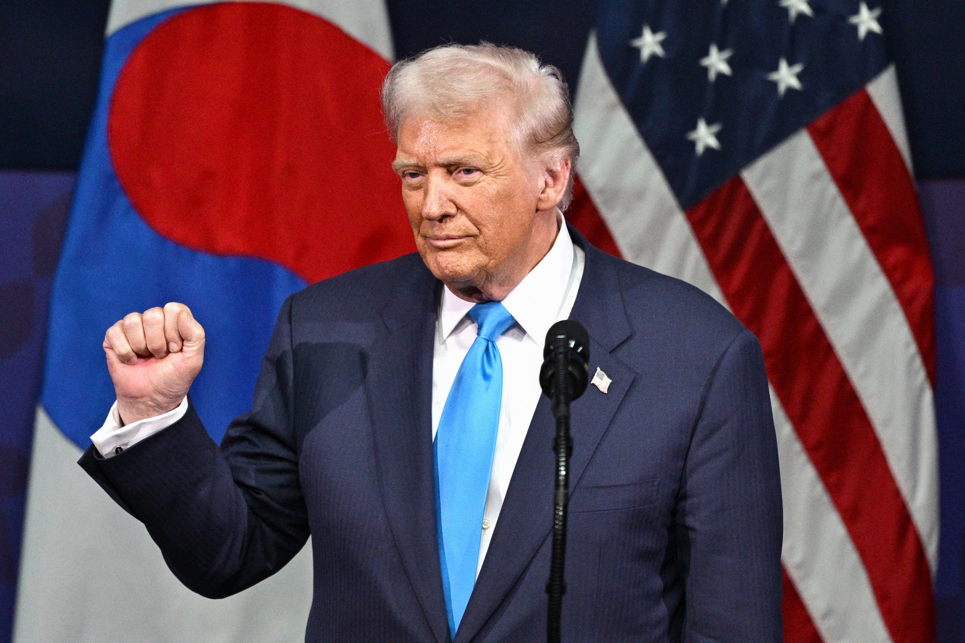<p>US President Donald Trump gestures as he speaks during the Asia-Pacific Economic Cooperation (APEC) CEO Summit </p>