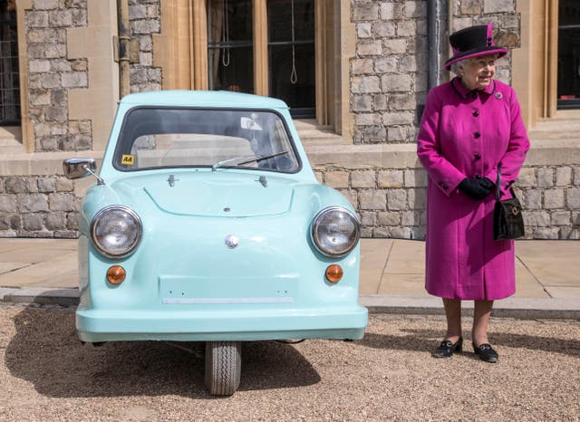 <p>Queen Elizabeth II stands next to a classic Invacar invalid carriage during a ceremony at Windsor Castle to celebrate the 40th anniversary of Motability in 2017</p>