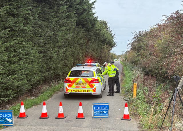 <p>Police officers man the cordon near the site of the helicopter crash</p>
