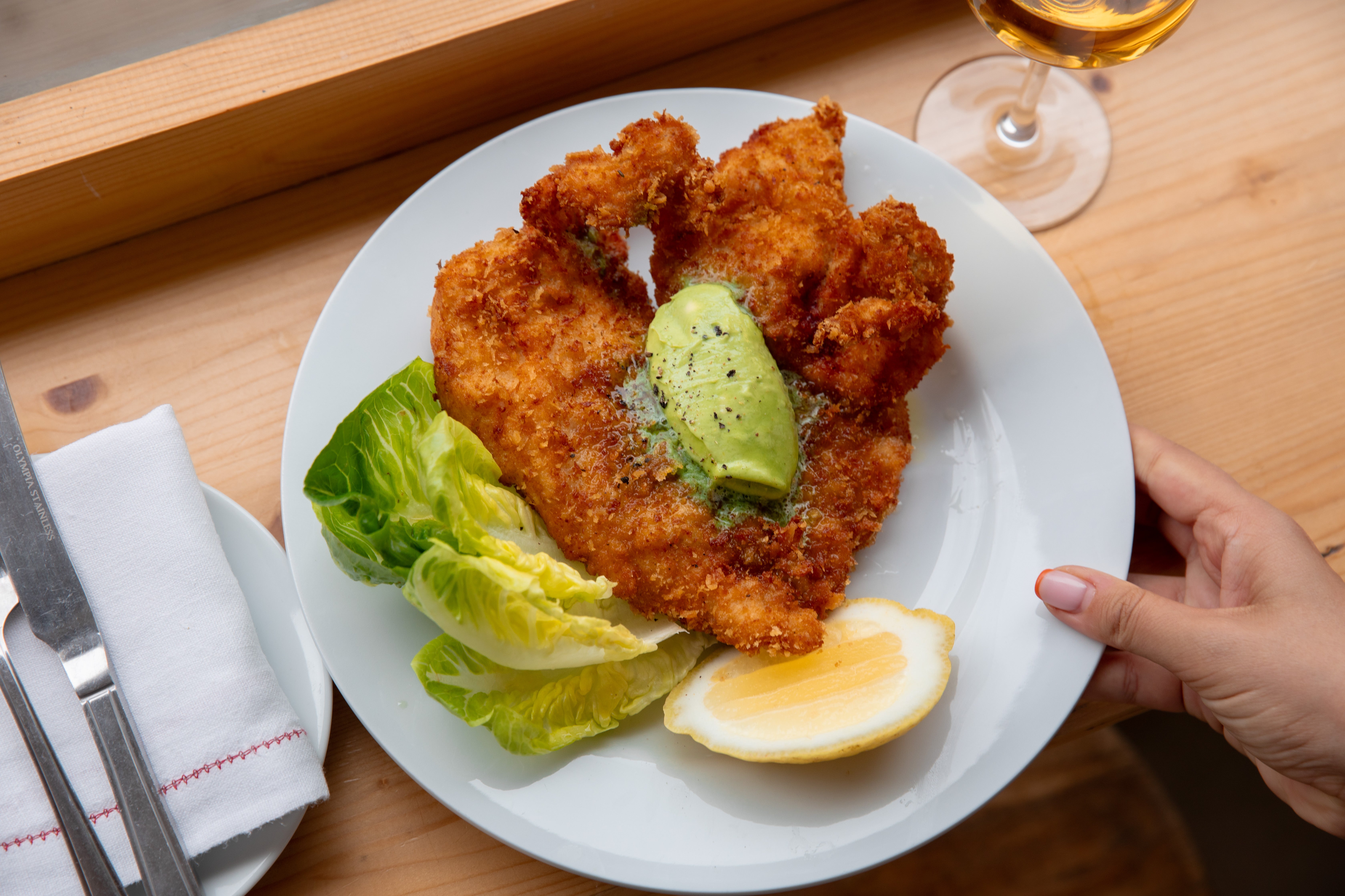 <p>Golden, crisp and unapologetically buttery – this kiev-style schnitzel proves sometimes simplicity really is the show-off</p>