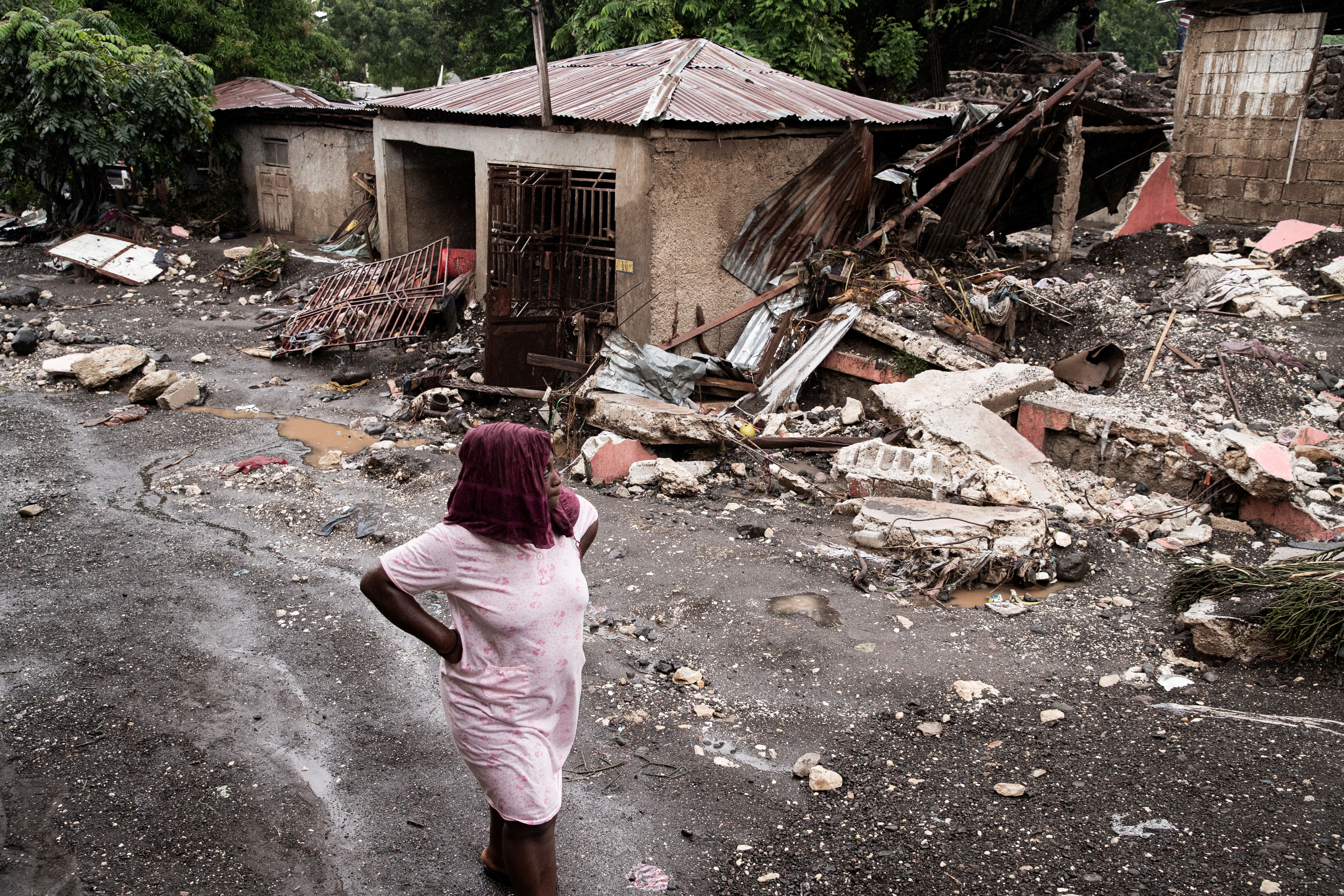 <p>A woman walks past her house that was destroyed by Hurricane Melissa in Petit-Goave, Haiti</p>