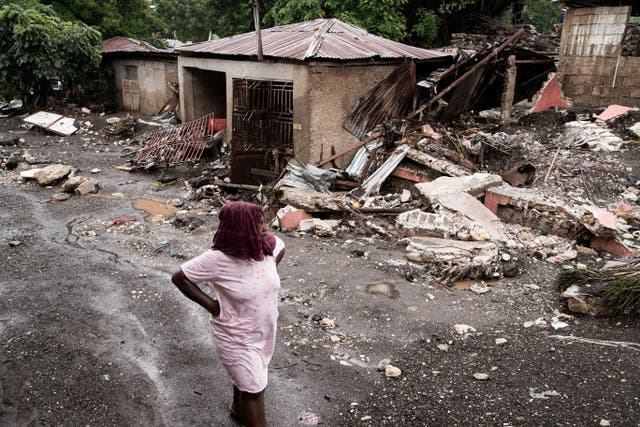 <p>A woman walks past her house that was destroyed by Hurricane Melissa in Petit-Goave, Haiti</p>