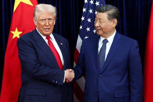 <p>Trump and Xi pose for reporters before their summit meeting in South Korea</p>