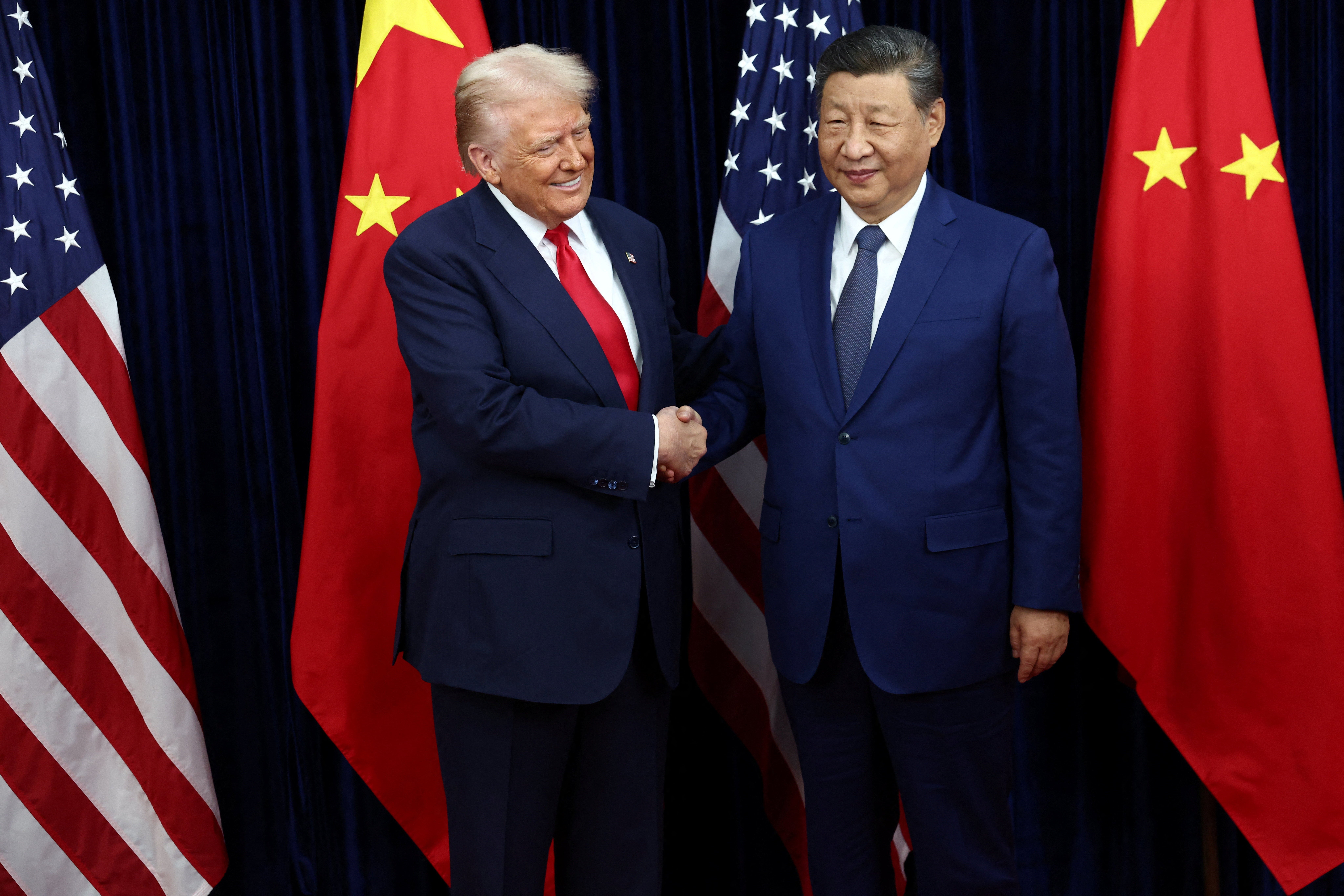 U.S. President Donald Trump greets Chinese President Xi Jinping as they hold a bilateral meeting at Gimhae International Airport, on the sidelines of the Asia-Pacific Economic Cooperation (APEC) summit, in Busan, South Korea