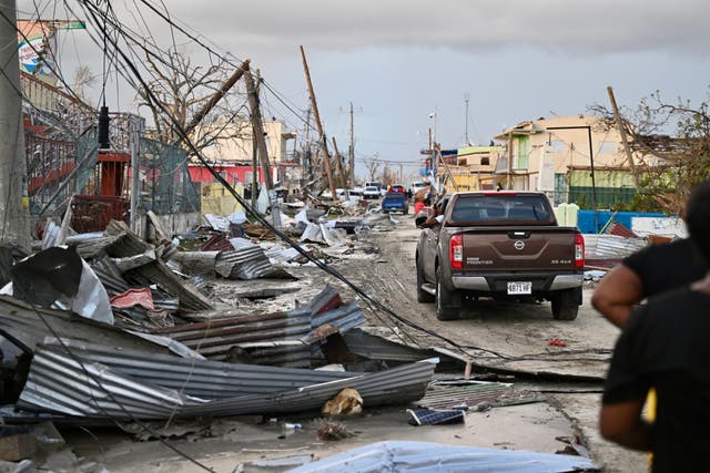 <p>A car drives through the a destroyed neighborood following the passage of Hurricane Melissa, in Black River, Jamaica</p>