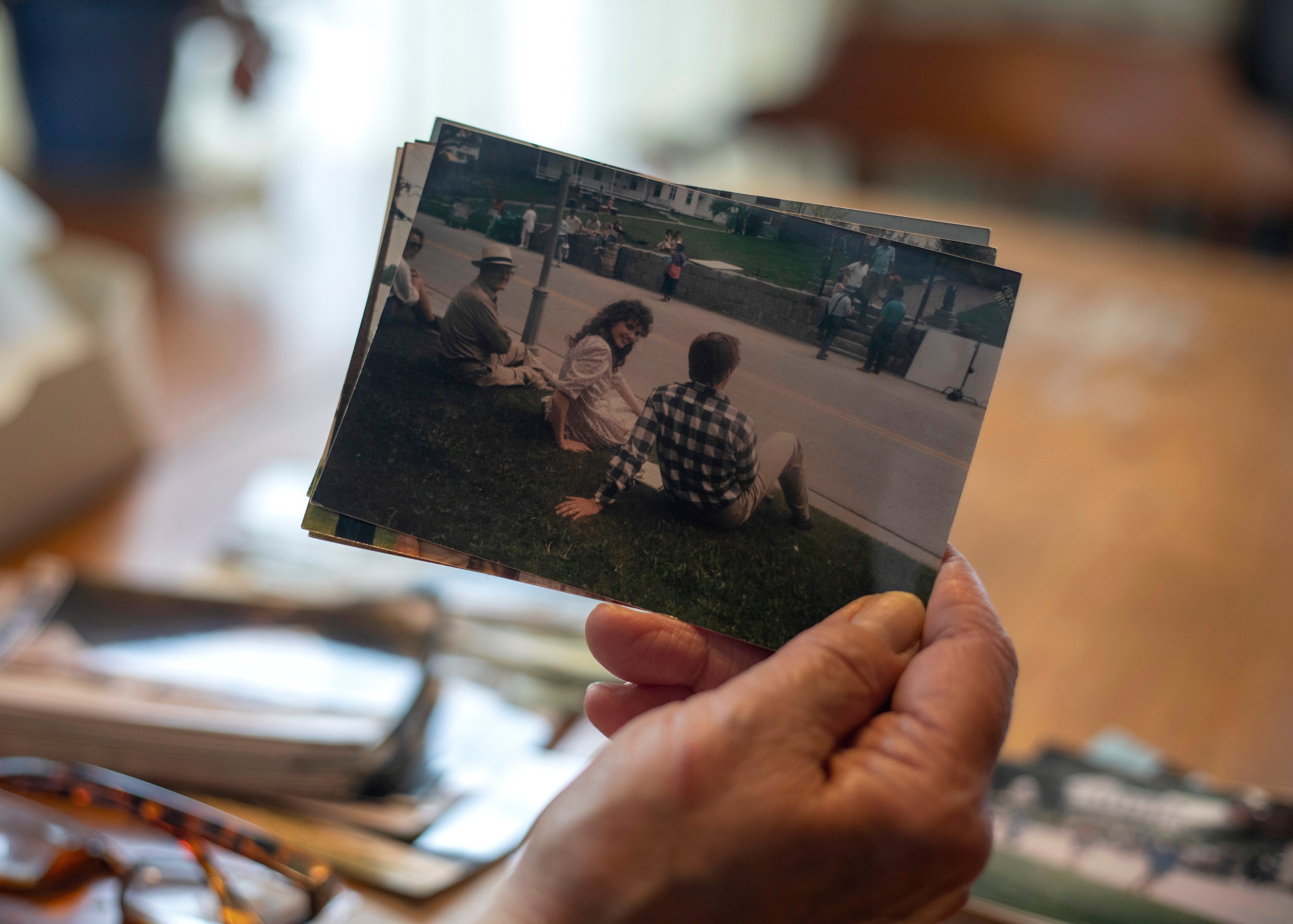 East Corinth resident Sarah Polli holds a photograph she took of actors Geena Davis and Alec Baldwin sitting on her front lawn during the 1987 filming of the first Beetlejuice film in East Corinth