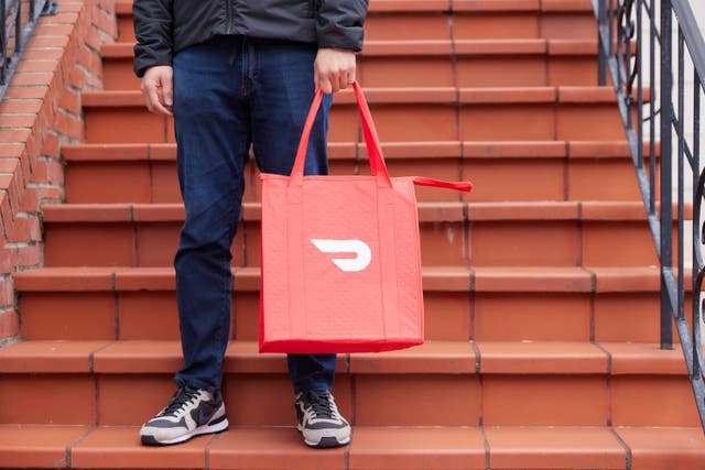<p>SAN FRANCISCO, CALIFORNIA - APRIL 2024: In this photo illustration, a person demonstrates making a delivery with DoorDash as a Dasher in April 2024 in San Francisco, California</p>