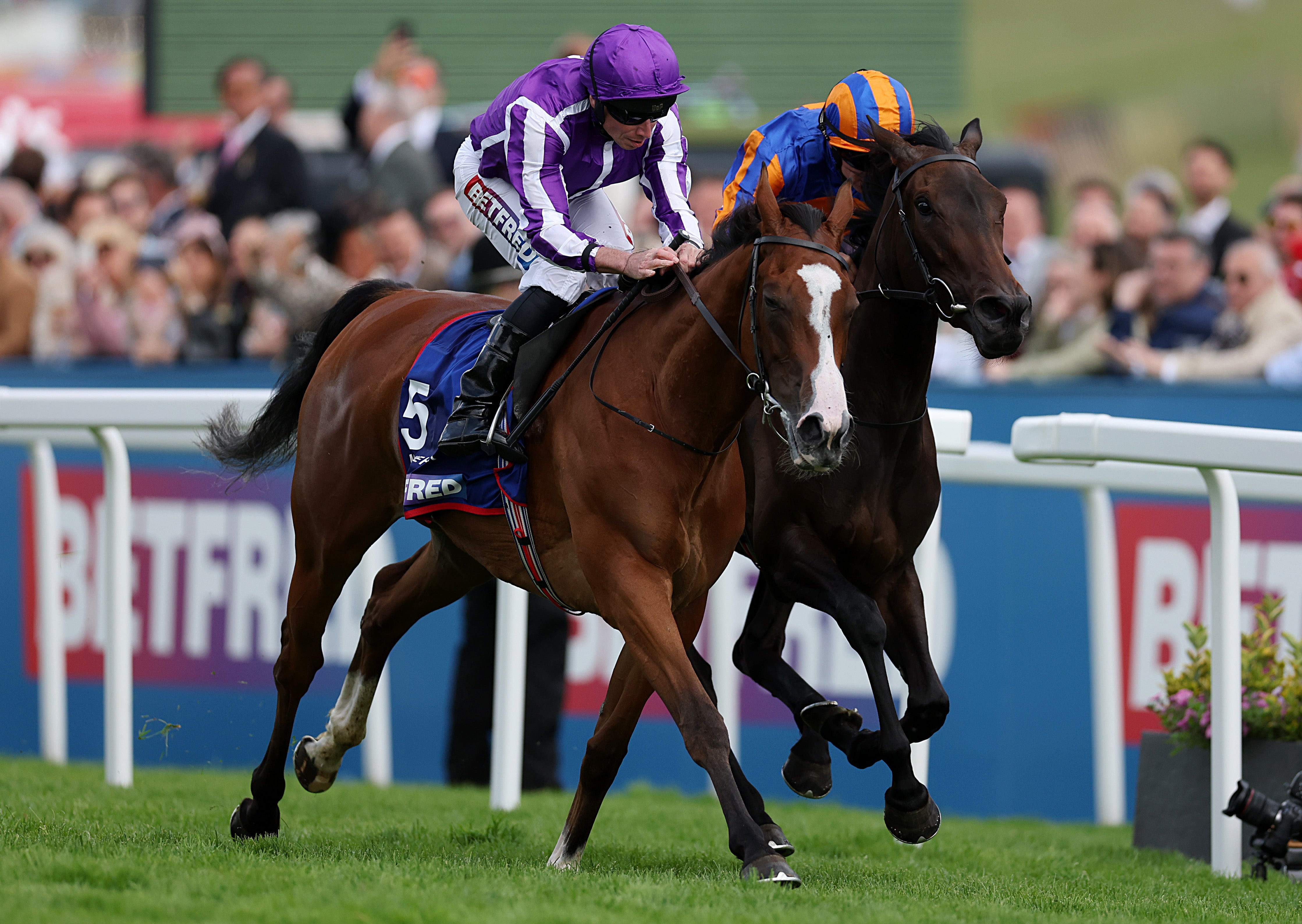 <p>Minnie Hauk with Ryan Moore at Epsom Downs Racecourse</p>