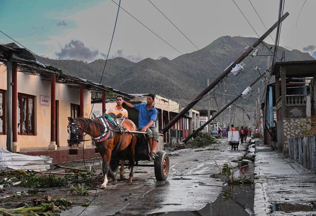 <p>Cubans ride in a horse-pulled cart past downed power lines following the passage of Hurricane Melissa. Climate finance to help countries like Cuba prepare for climate shocks like hurricanes is too hard to access at the moment, according to a technical expert</p>