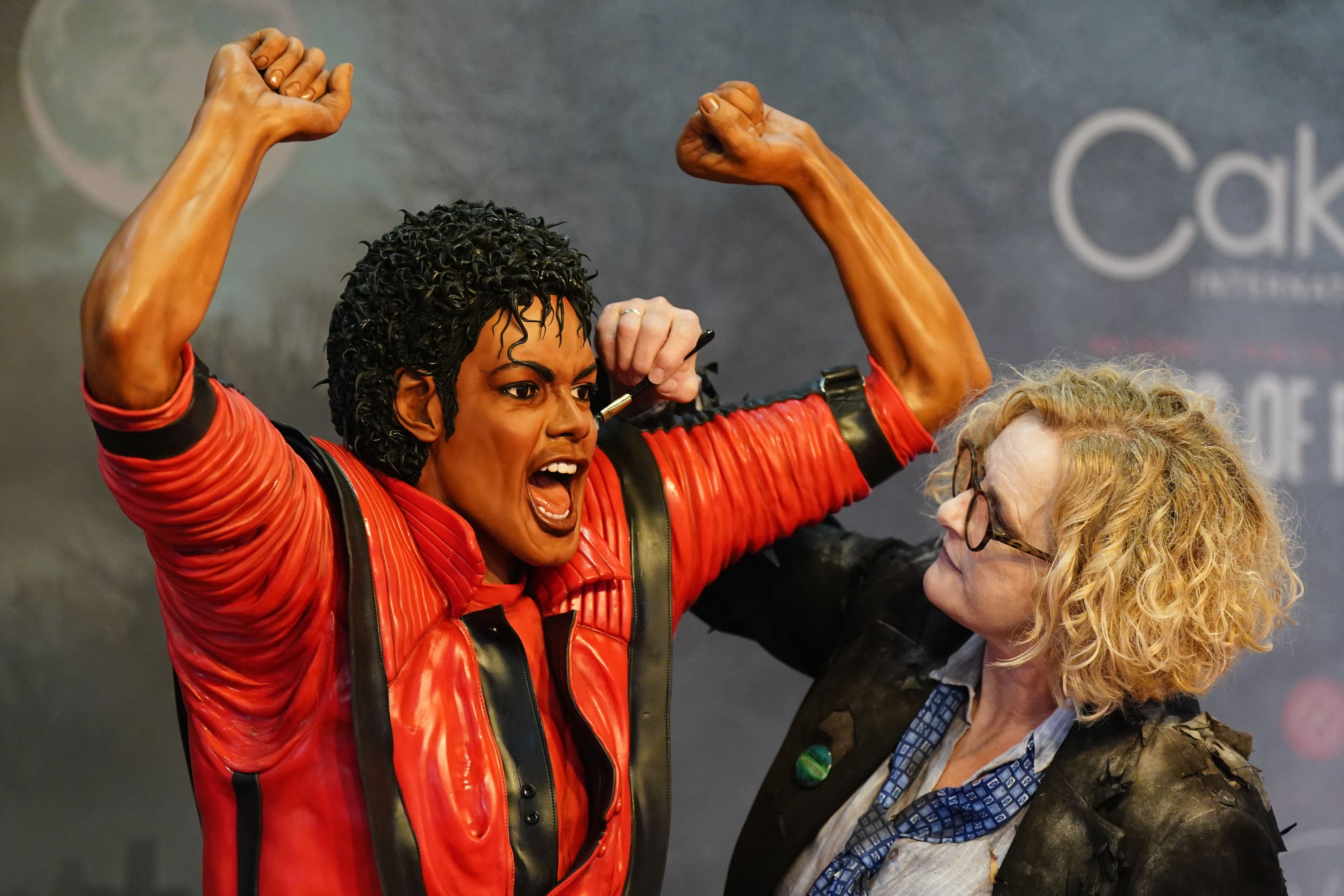 Cake artist Emma Jayne Morris works on her life-size replica of Michael Jackson during the Cake International show at the NEC in Birmingham (Jacob King/PA)