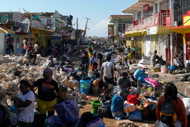 <p>Residents gather amid debris in Black River, Jamaica, in the aftermath of Hurricane Melissa</p>