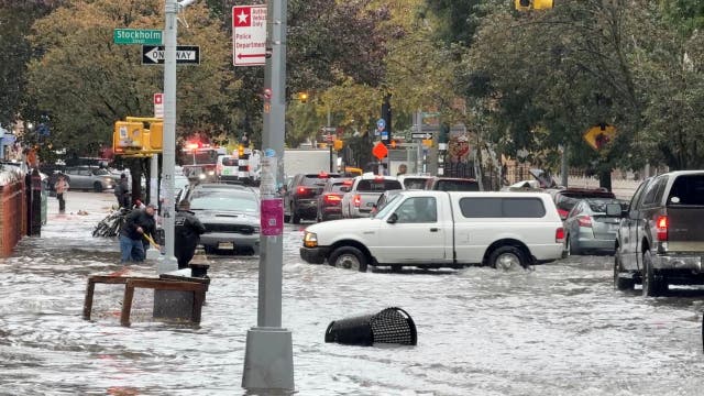 <p>Vehicles move through flooded streets in New York City on Thursday. The rainfall broke three daily records in the region</p>
