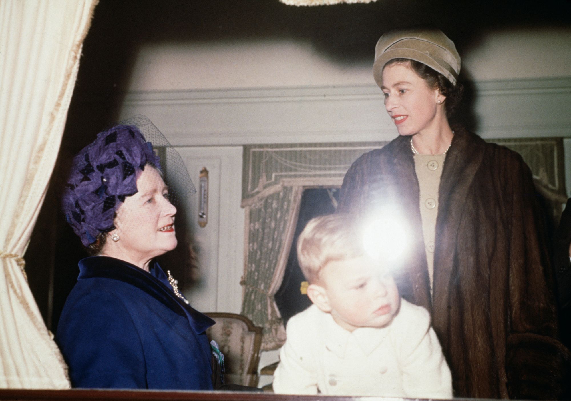 Prince Andrew, Queen Elizabeth II and the Queen Mother aboard the royal train en route to Sandringham House in Norfolk for Christmas, on 21 December 1961