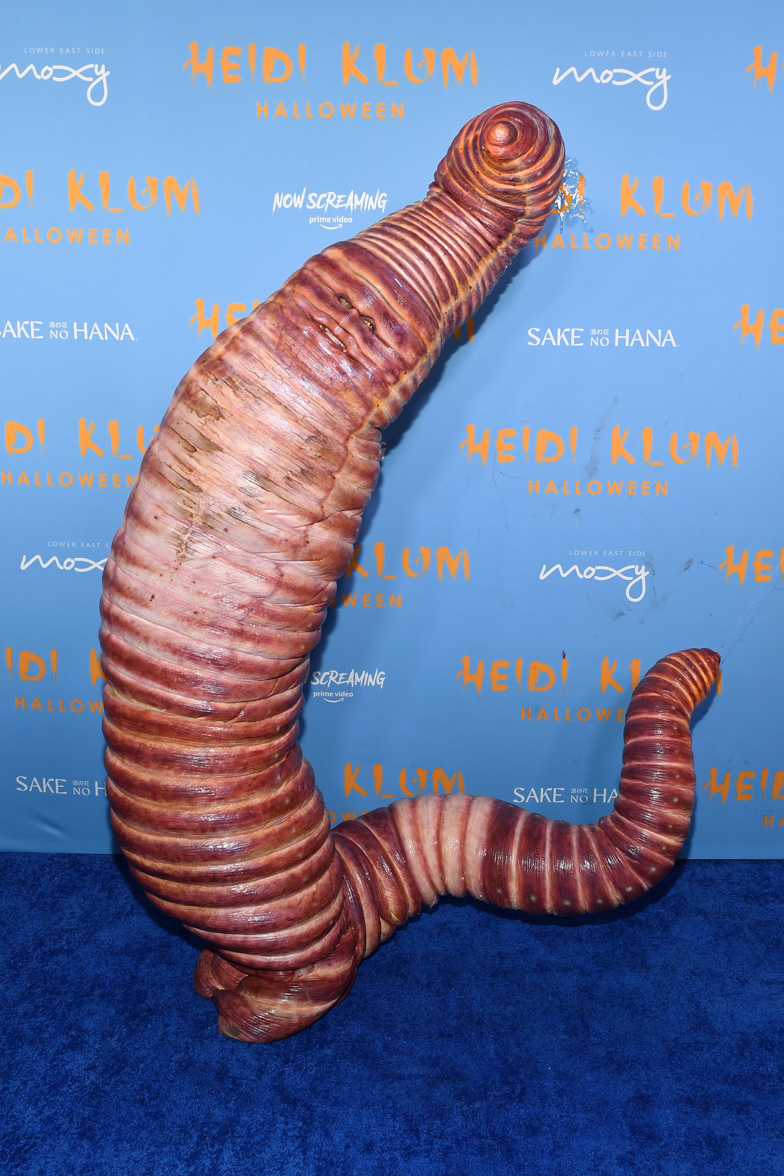 In 2022, Klum transformed into a giant worm, with her face barely visible and only yellow eyes indicating that someone was in the costume