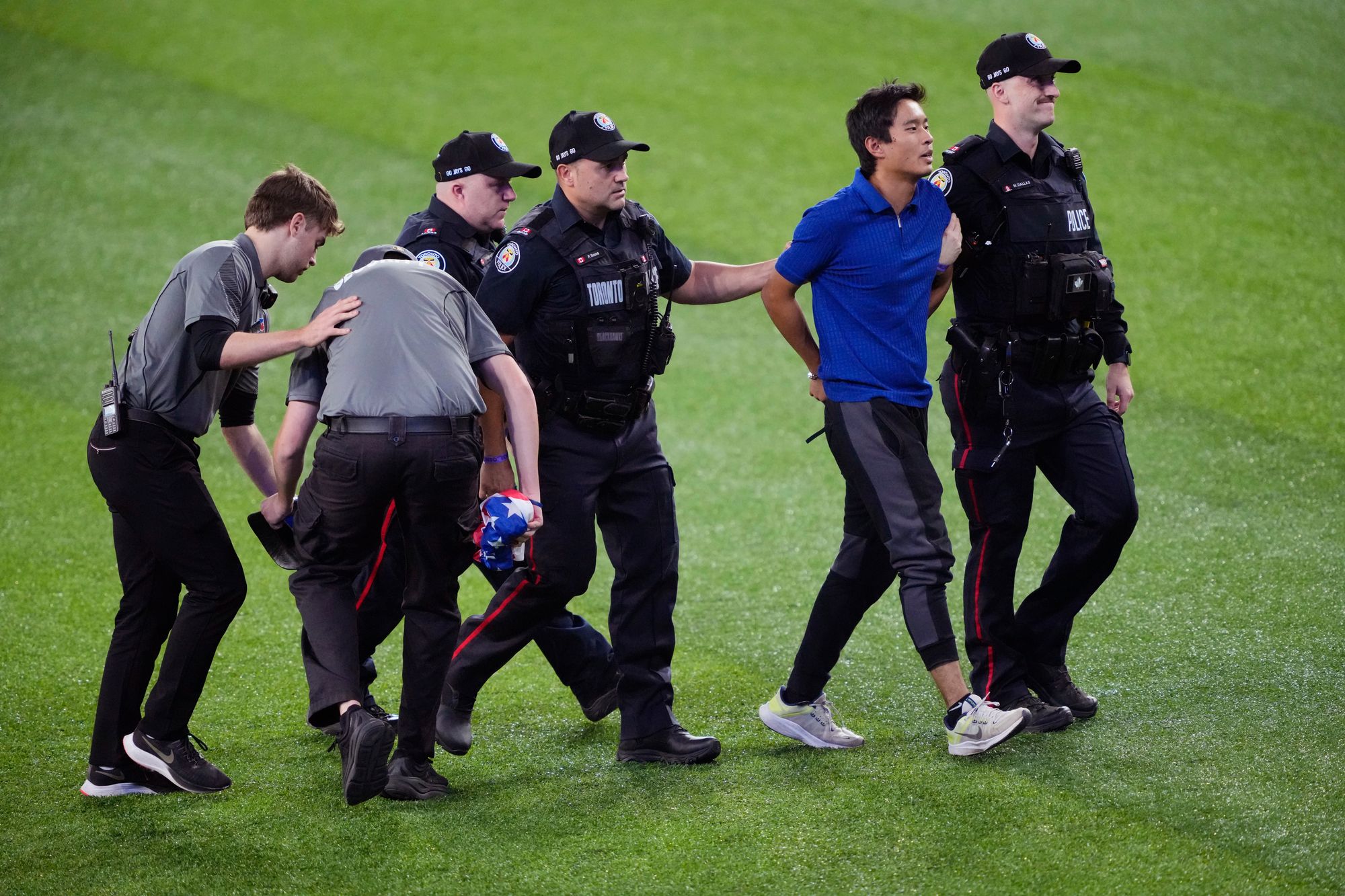 The stadium booed the man as police escorted him off the field