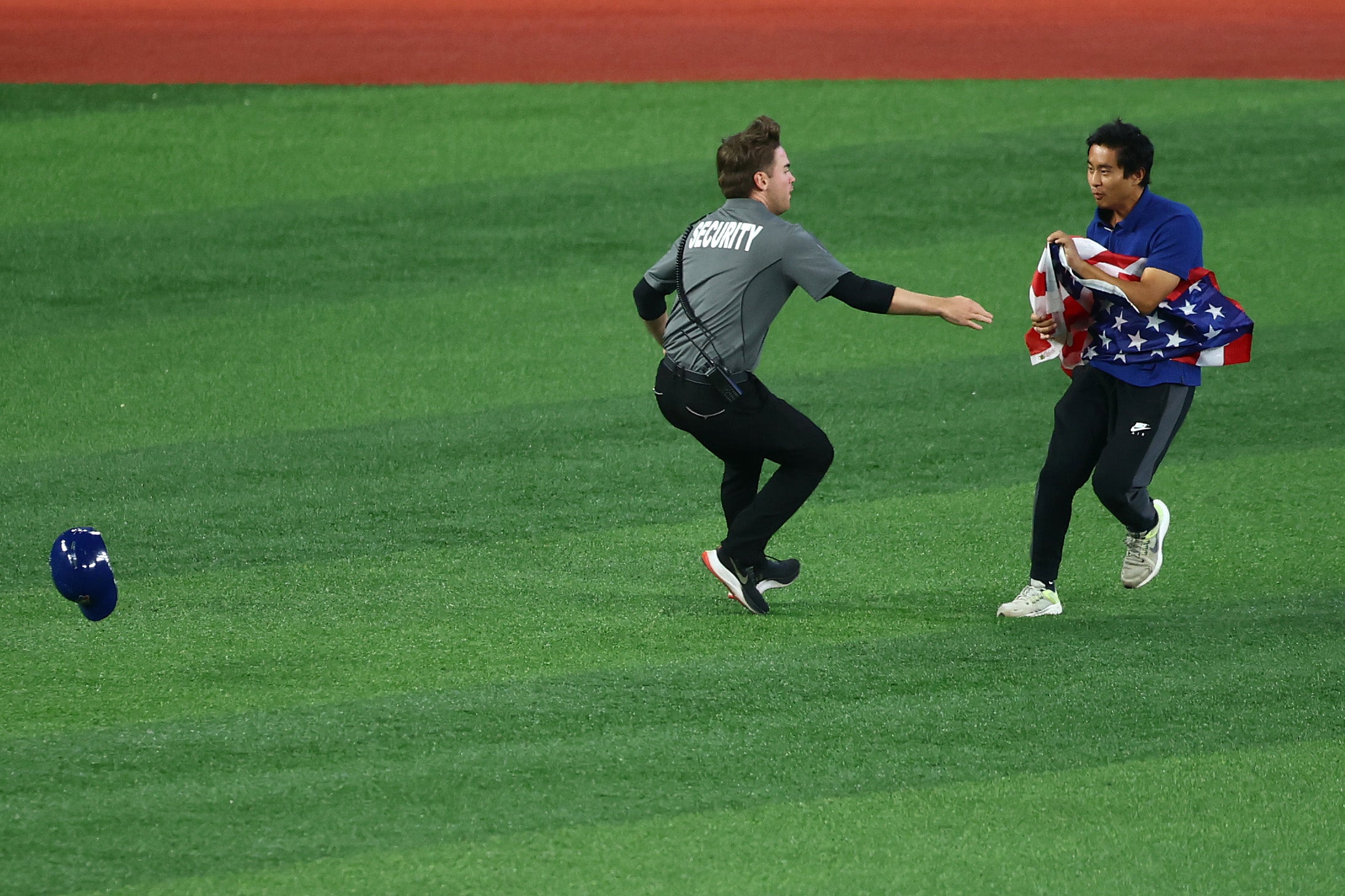 Security guards quickly intercepted the fan on the field, tackling him to the ground