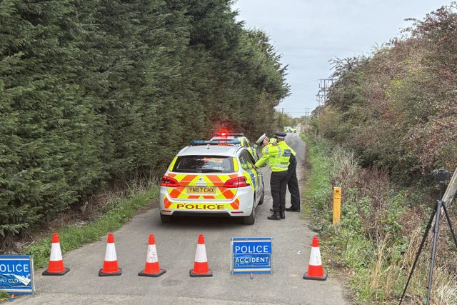 Police officers man the cordon near the site of the helicopter crash (Dave Higgens/PA)