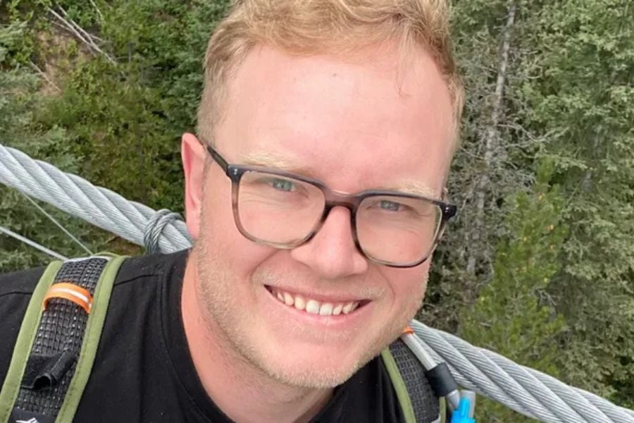 Jesse Sayer’s condition improved to non-life-threatening on Friday, a day after he was mauled by a grizzly bear in Alberta, Canada