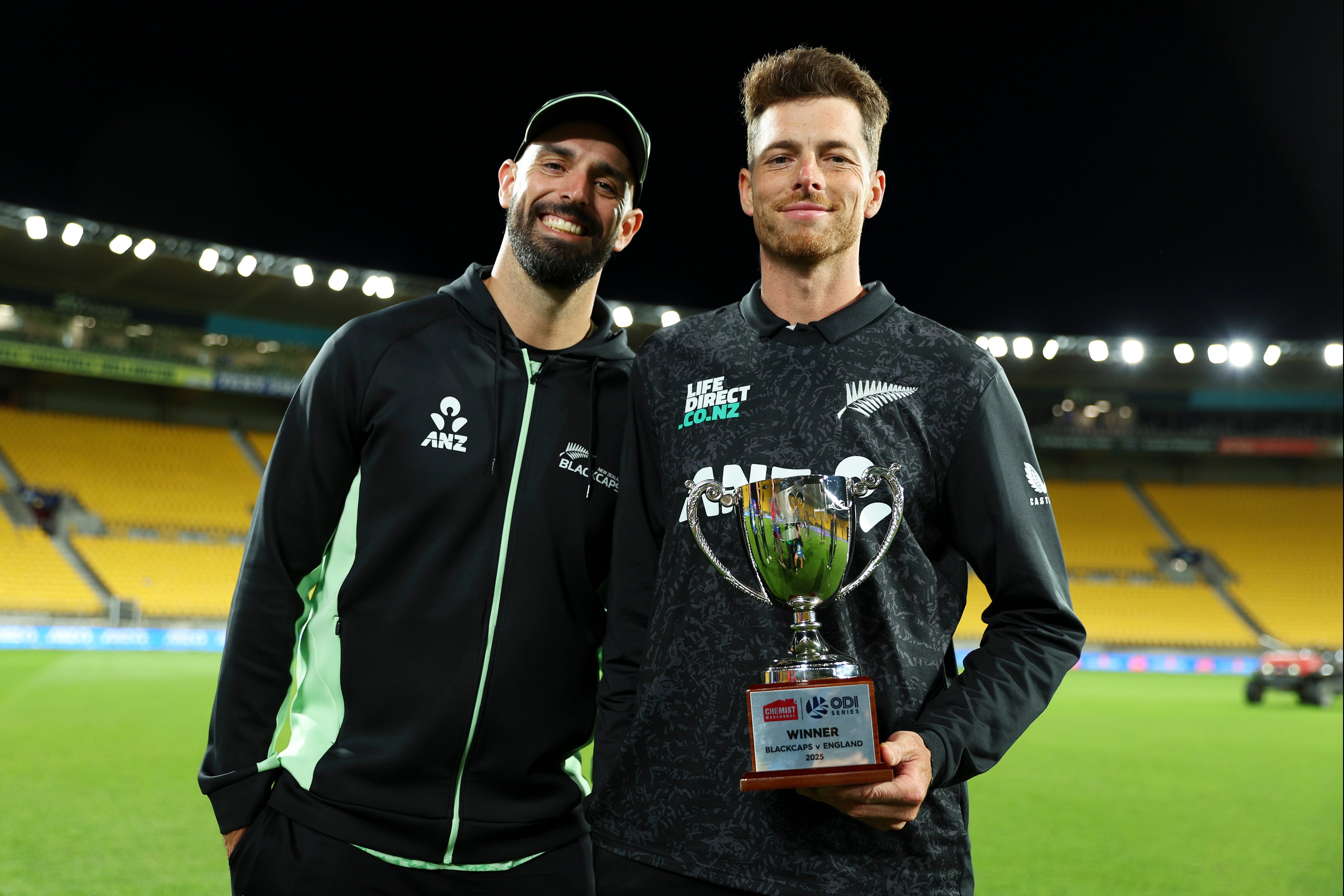 Daryl Mitchell (L) and Mitchell Santner of New Zealand pose with the series trophy