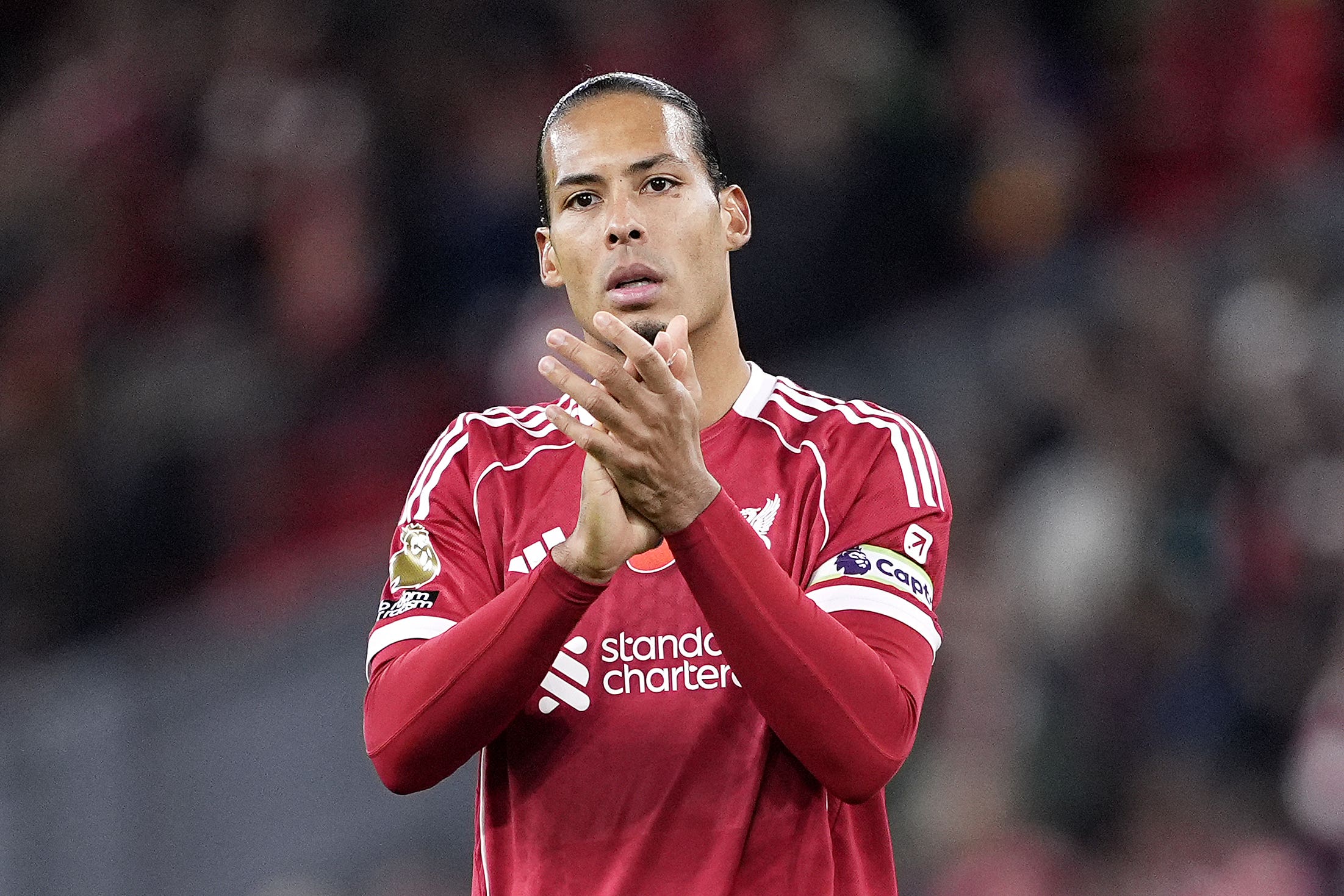 Liverpool captain Virgil van Dijk applauds fans after the 2-0 win over Aston Villa at Anfield (Peter Byrne/PA).