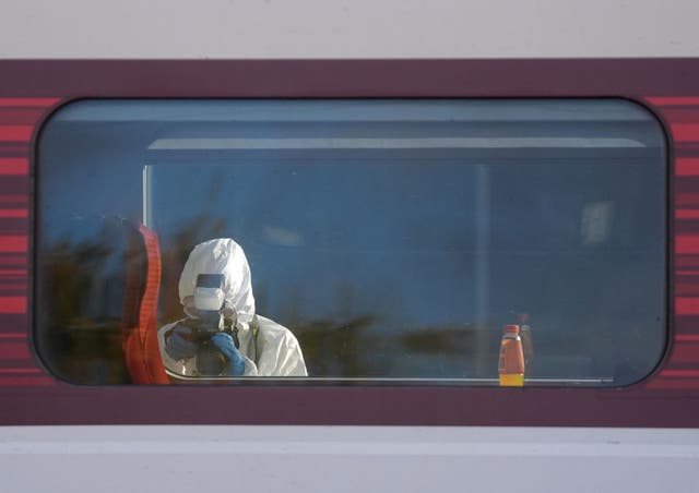 <p>Forensic investigators are continuing to work at Huntingdon railway station in Cambridgeshire (Joe Giddens/PA)</p>