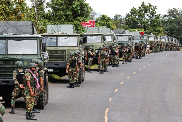 <p>Cambodian soldiers stand next to a convoy of rocket launchers in Preah Vihear province</p>
