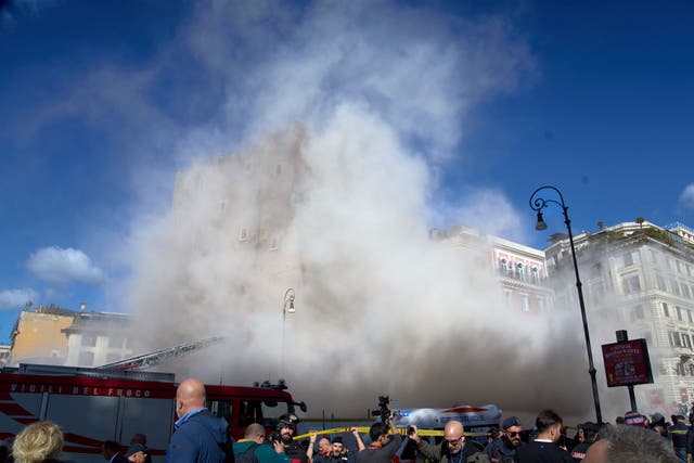 <p>Torre dei Conti near the Roman Forum is engulfed by a cloud of debris following a second collapse </p>