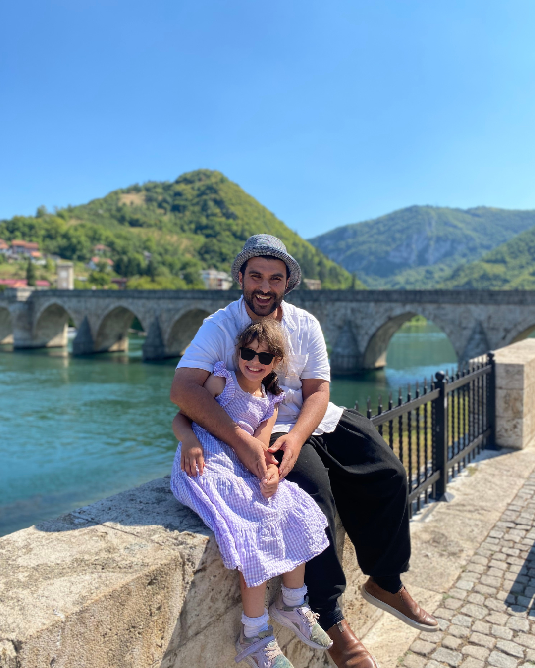 Hamdi, pictured here with his daughter, has been detained for a week