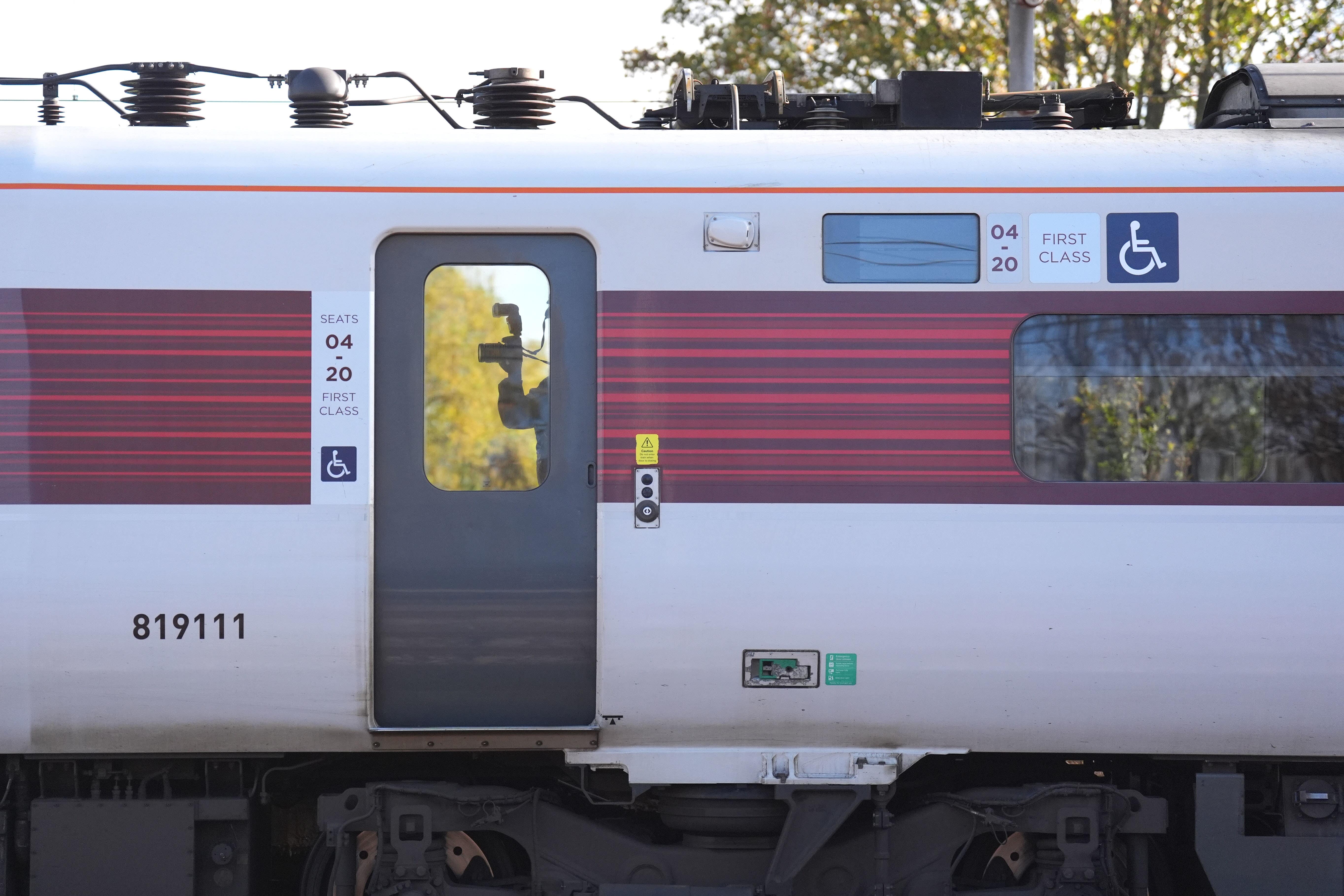 A forensic investigator photographing inside the train at Huntingdon train station in Cambridgeshire, after a number of people were stabbed on the train on Saturday (Joe Giddens/PA)