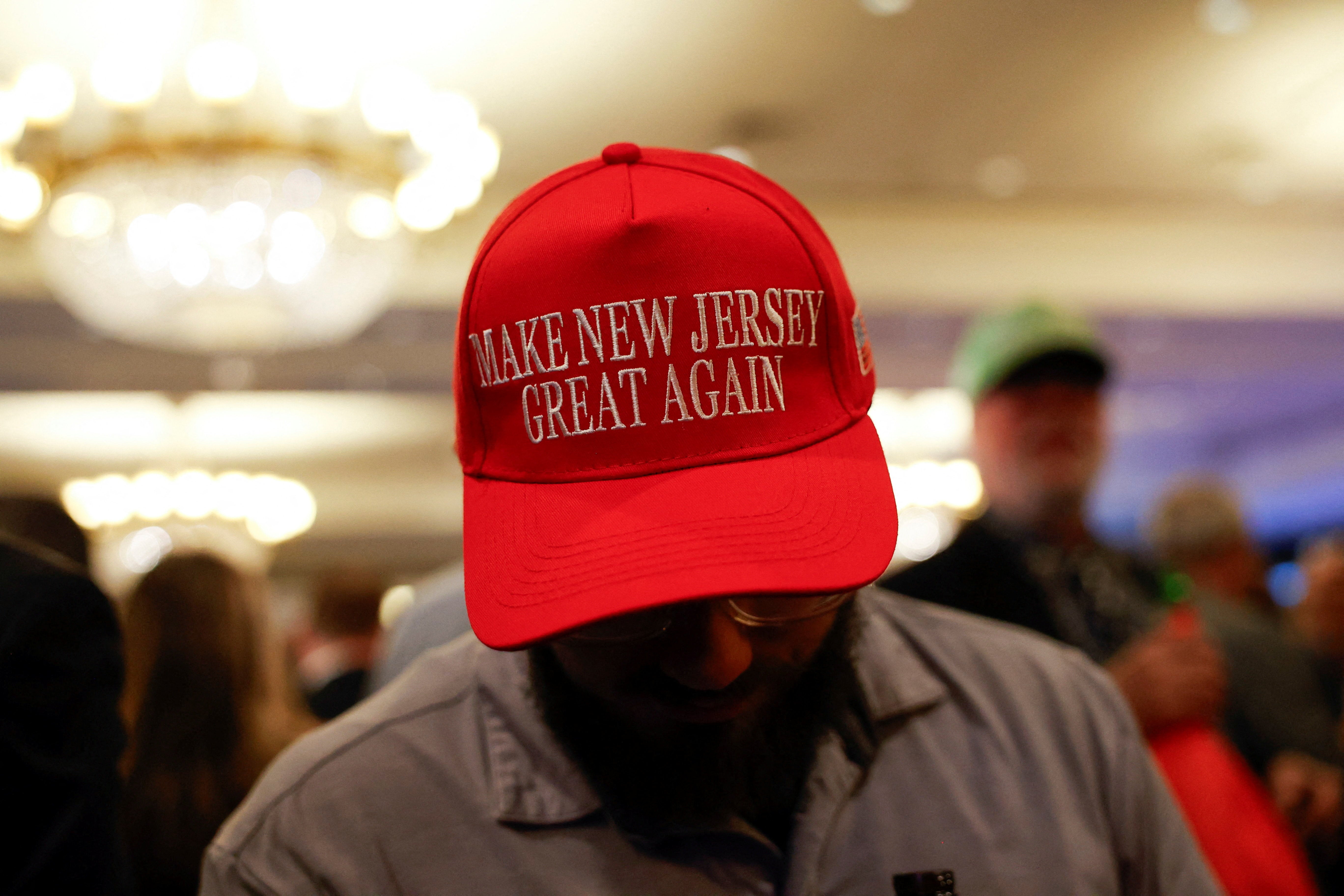 A supporter wearing a ‘Make New Jersey Great Again’ hat attends the election night rally for Republican gubernatorial candidate Jack Ciattarelli in Bridgewater on Tuesday