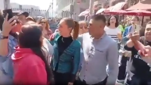 <p>A man came from behind Sheinbaum (centre) while she was walking about during a public appearance</p>