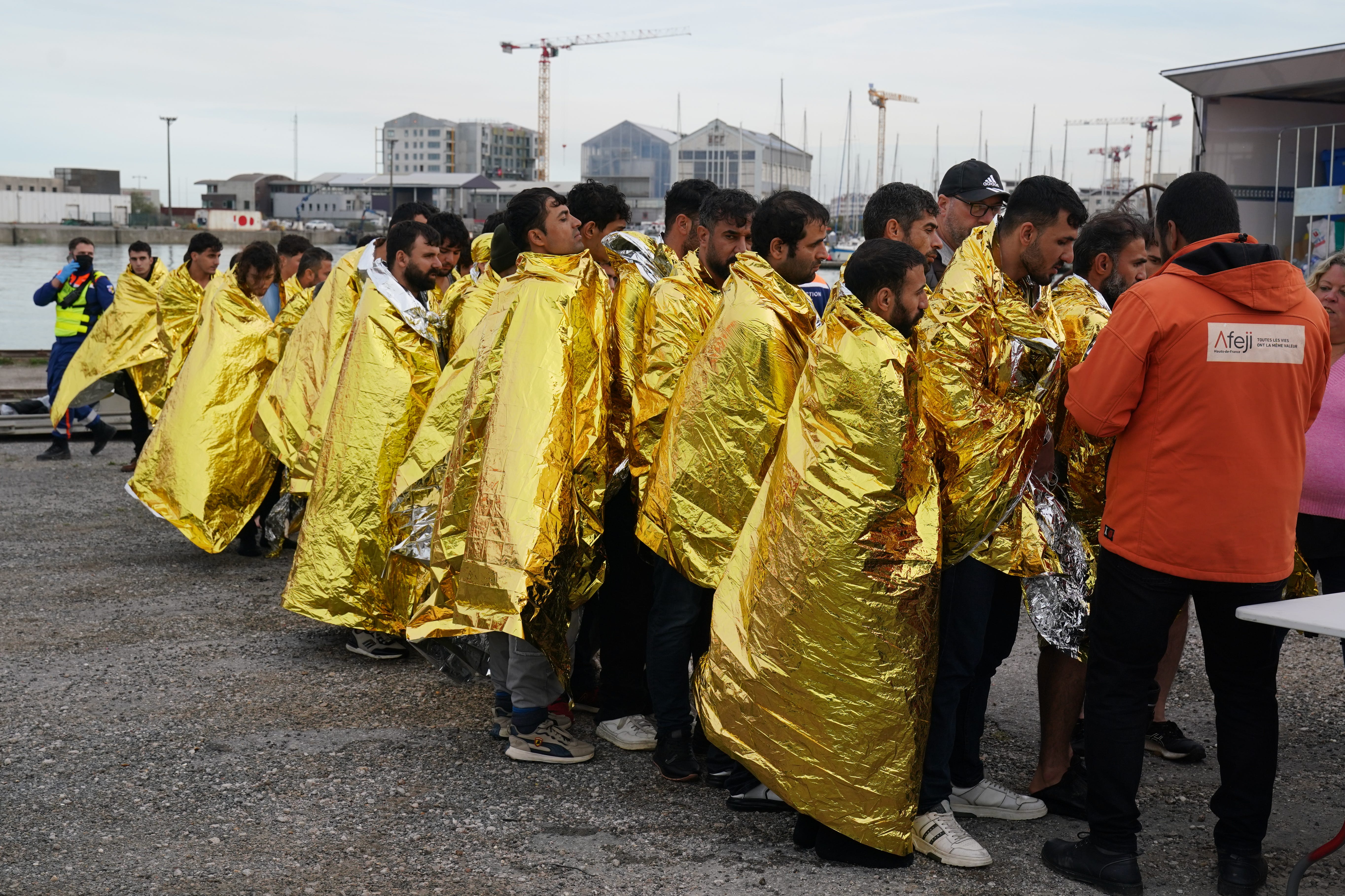 People thought to be migrants are assisted by French authorities in Dunkirk (Gareth Fuller/PA)