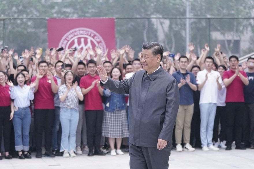 <p>Chinese President Xi Jinping waves to teachers and students during a visit to Renmin University of China in Beijing,</p>