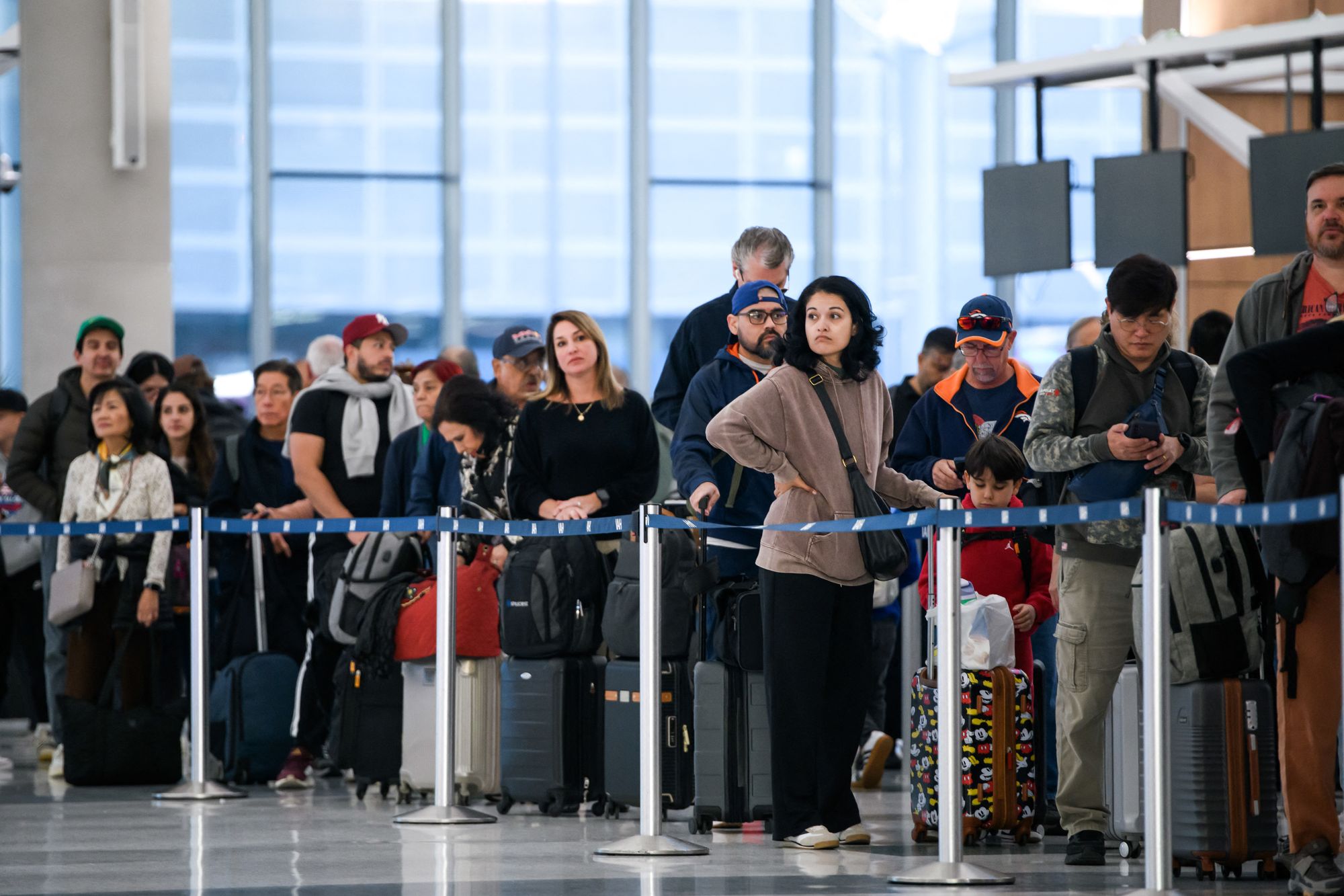 <p>People wait in a security checkpoint line at George Bush Intercontinental Airport in Houston, Texas, on November 4, 2025. With the federal government shutdown entering its second month, lines at airports are expected to grow amid increased absenteeism among security and safety staff at some of the country's busiest hubs</p>