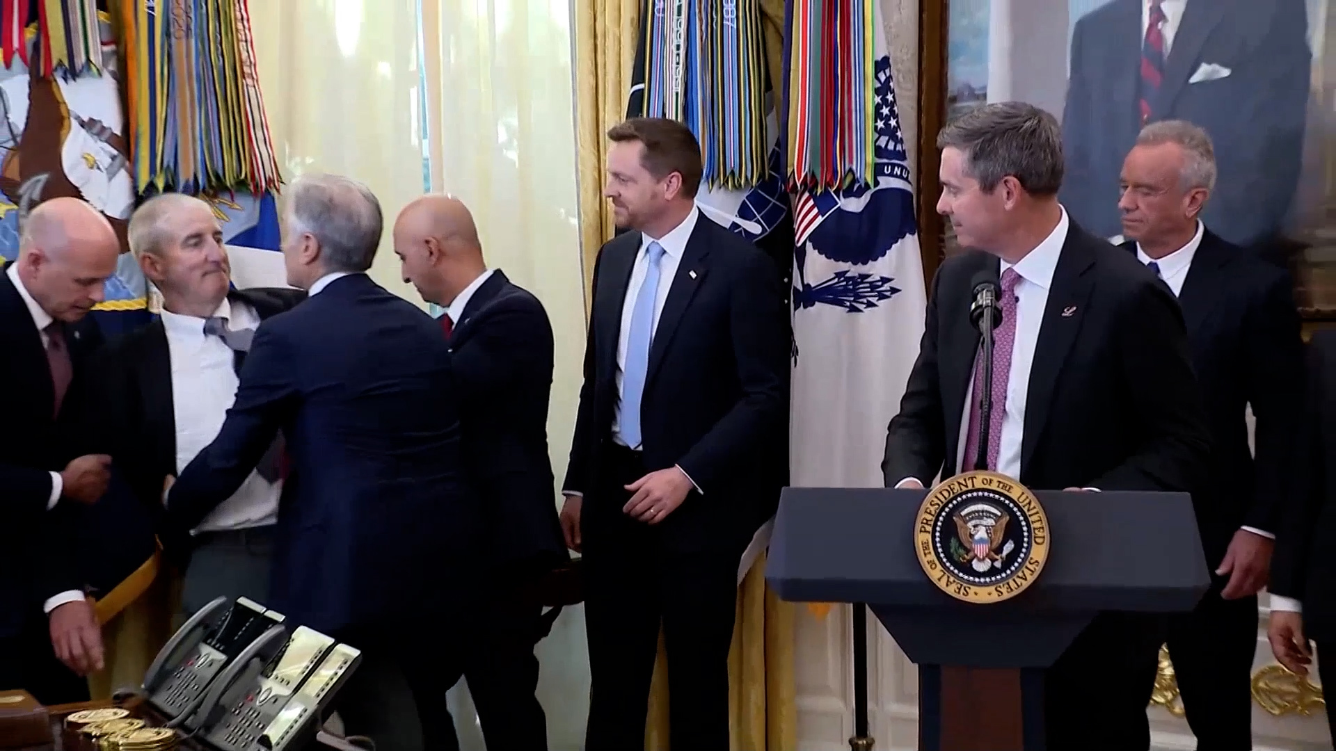 Official passes out in Oval Office while standing behind Trump for drug price announcement