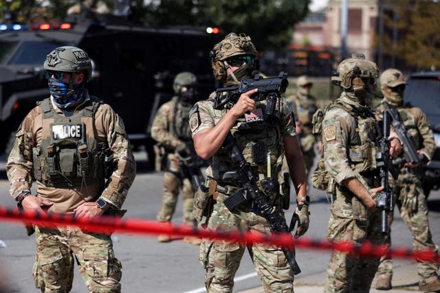<p>Law enforcement officers during a standoff between federal agents and protesters in the Little Village neighborhood of Chicago last month</p>