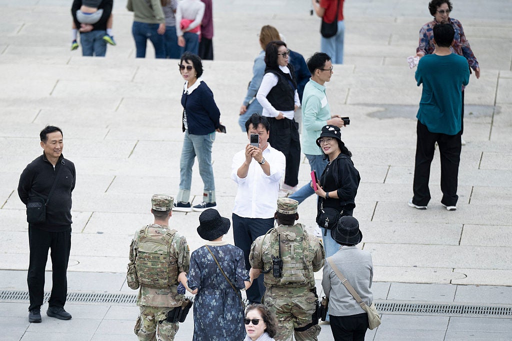 The reaction to a Guard deployment in D.C. has been mixed, with angry residents taking out their anger by hurling abuse at federal law enforcement, some showing understanding, and tourists gawking at the show