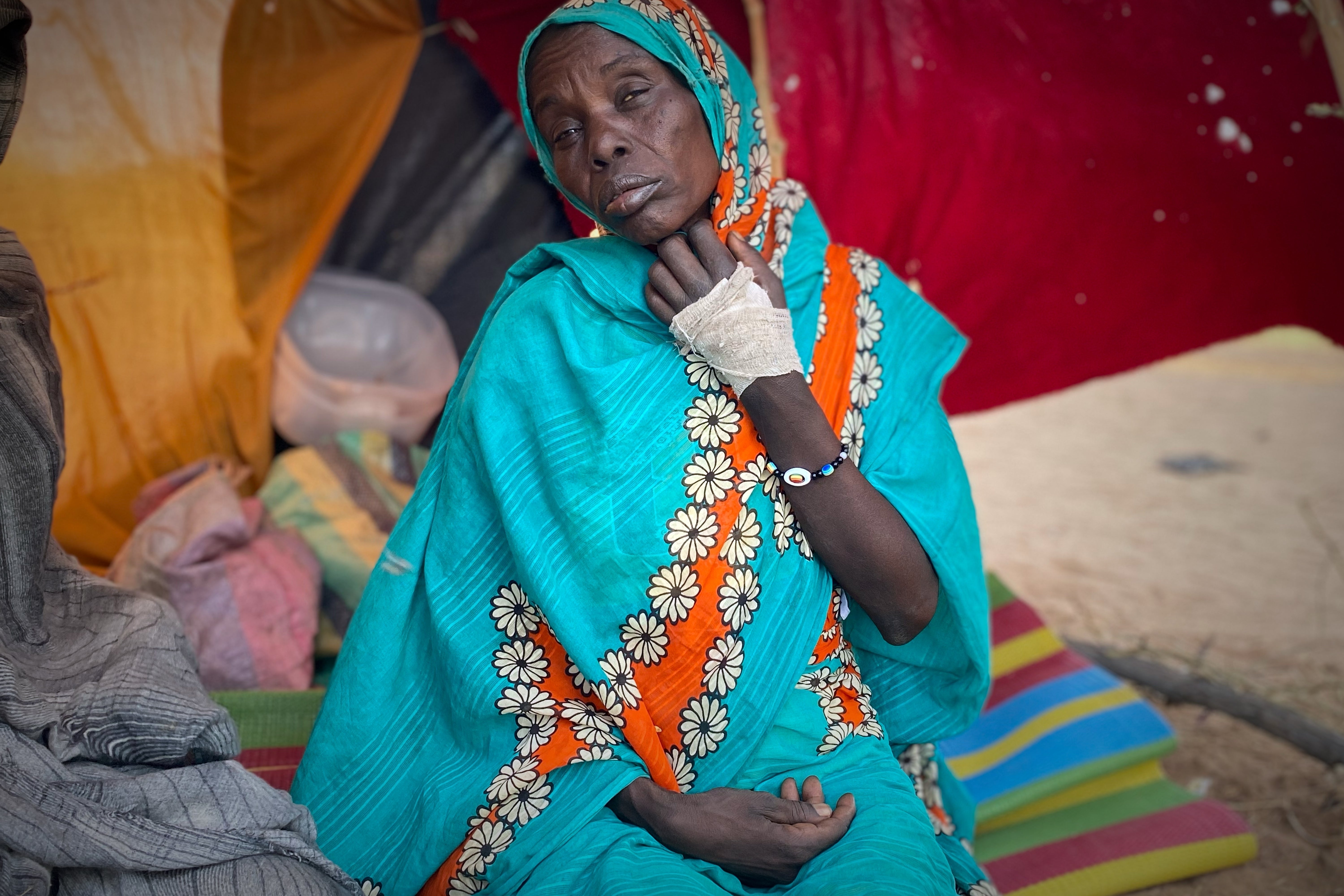 A woman who fled el-Fasher, after Sudan's paramilitary forces killed hundreds of people in the western Darfur region, rests at a camp in Tawila, Sudan
