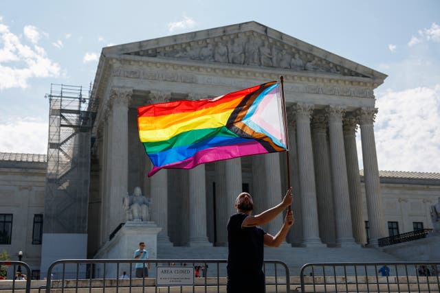 <p>Same-sex marriage supporter Vin Testa, of Washington, DC, waves a LGBTQIA pride flag in front of the U.S. Supreme Court Building</p>