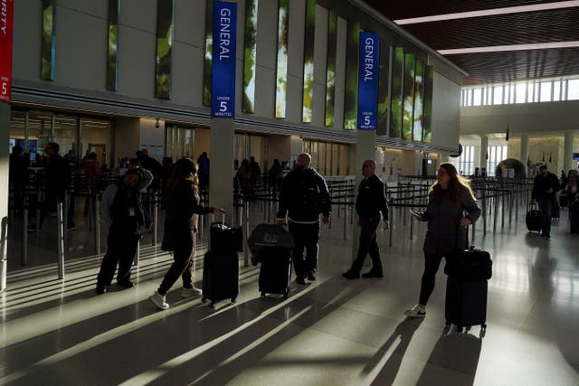 People walking through an airport terminal 