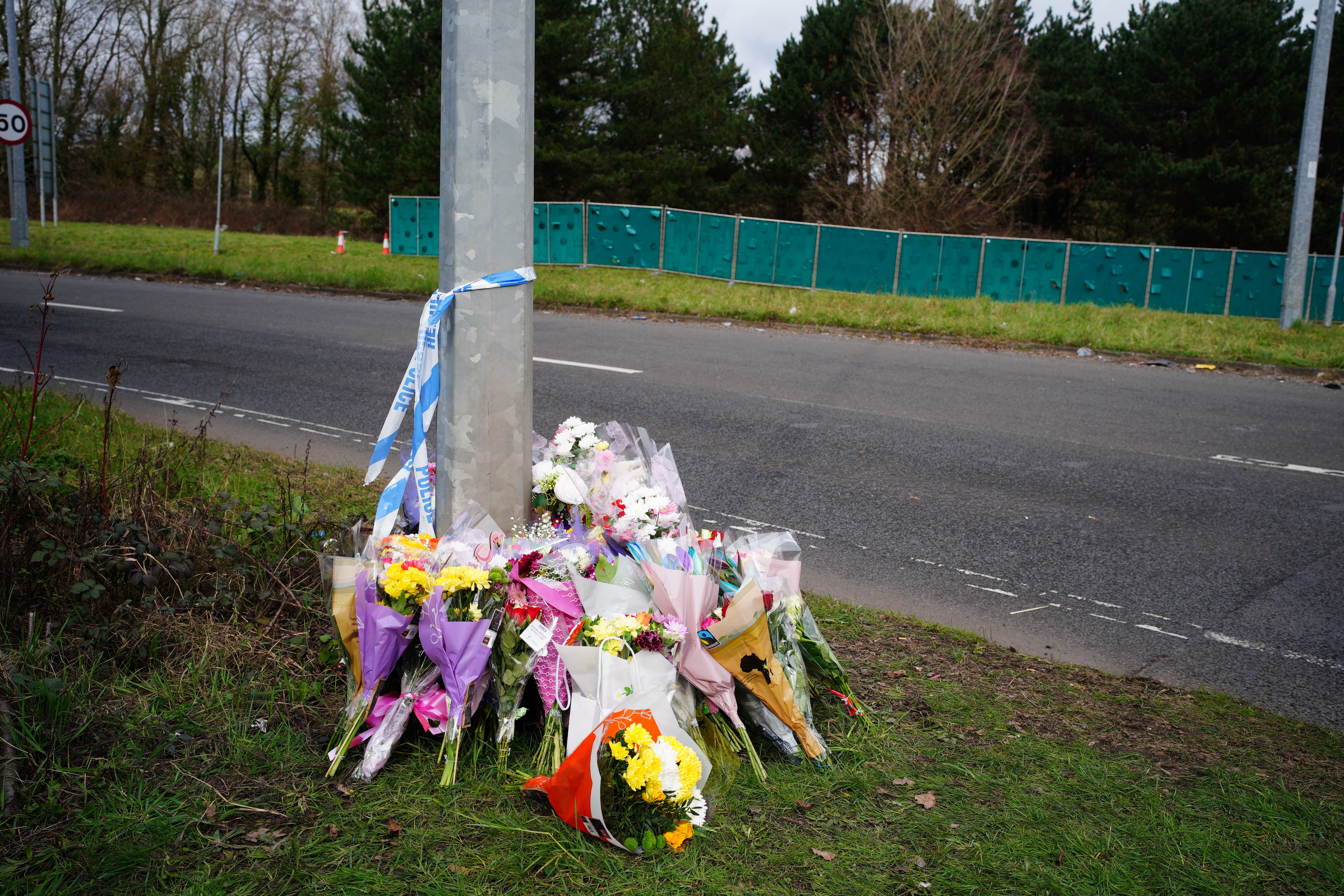 Floral tributes left near the scene in the St Mellons area of Cardiff (Ben Birchall/PA)