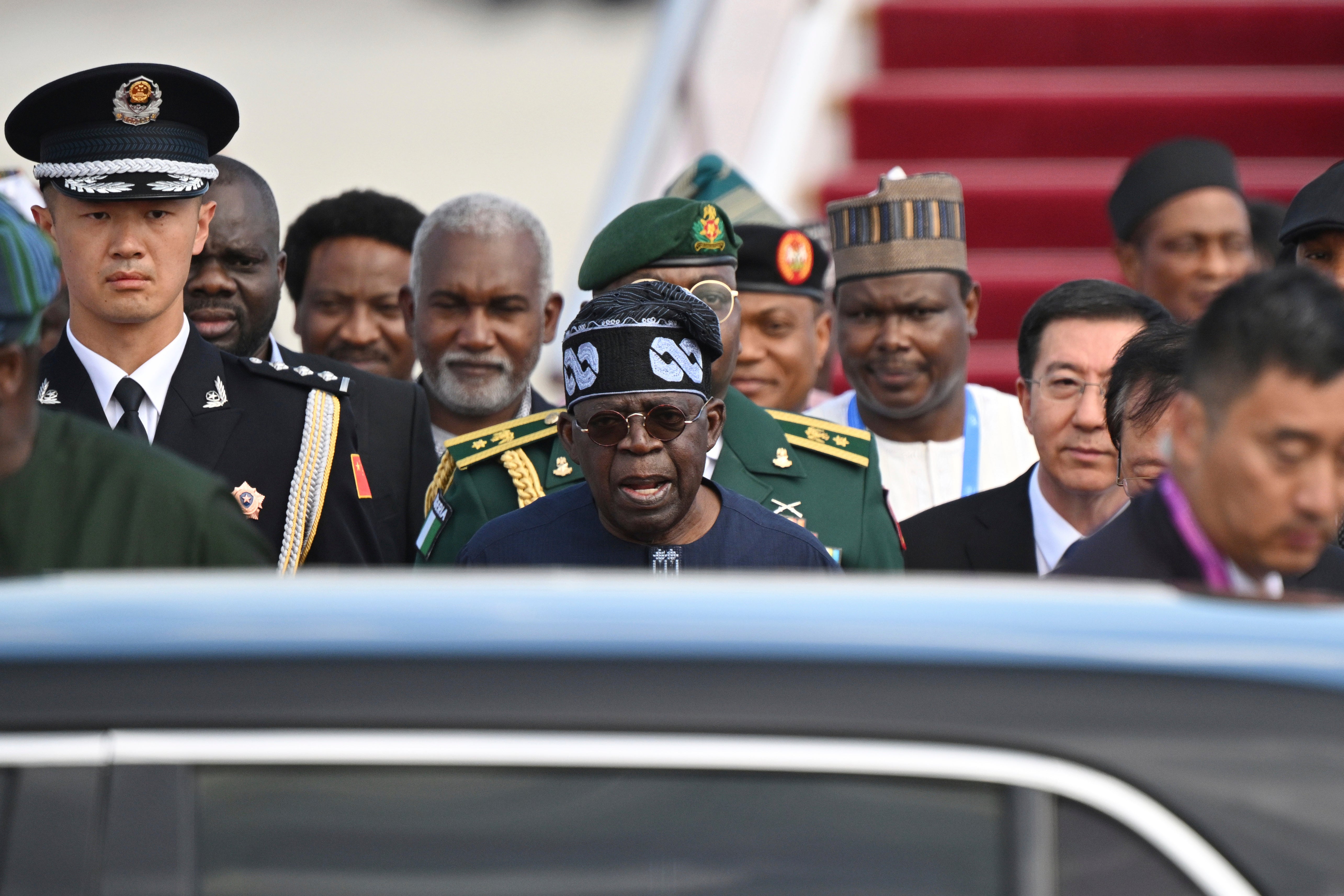 Nigerian President Bola Ahmed Tinubu, center, arrives at Beijing Capital International Airport in Beijing, Sept. 1, 2024. (Greg Baker/Pool Photo via AP, File)