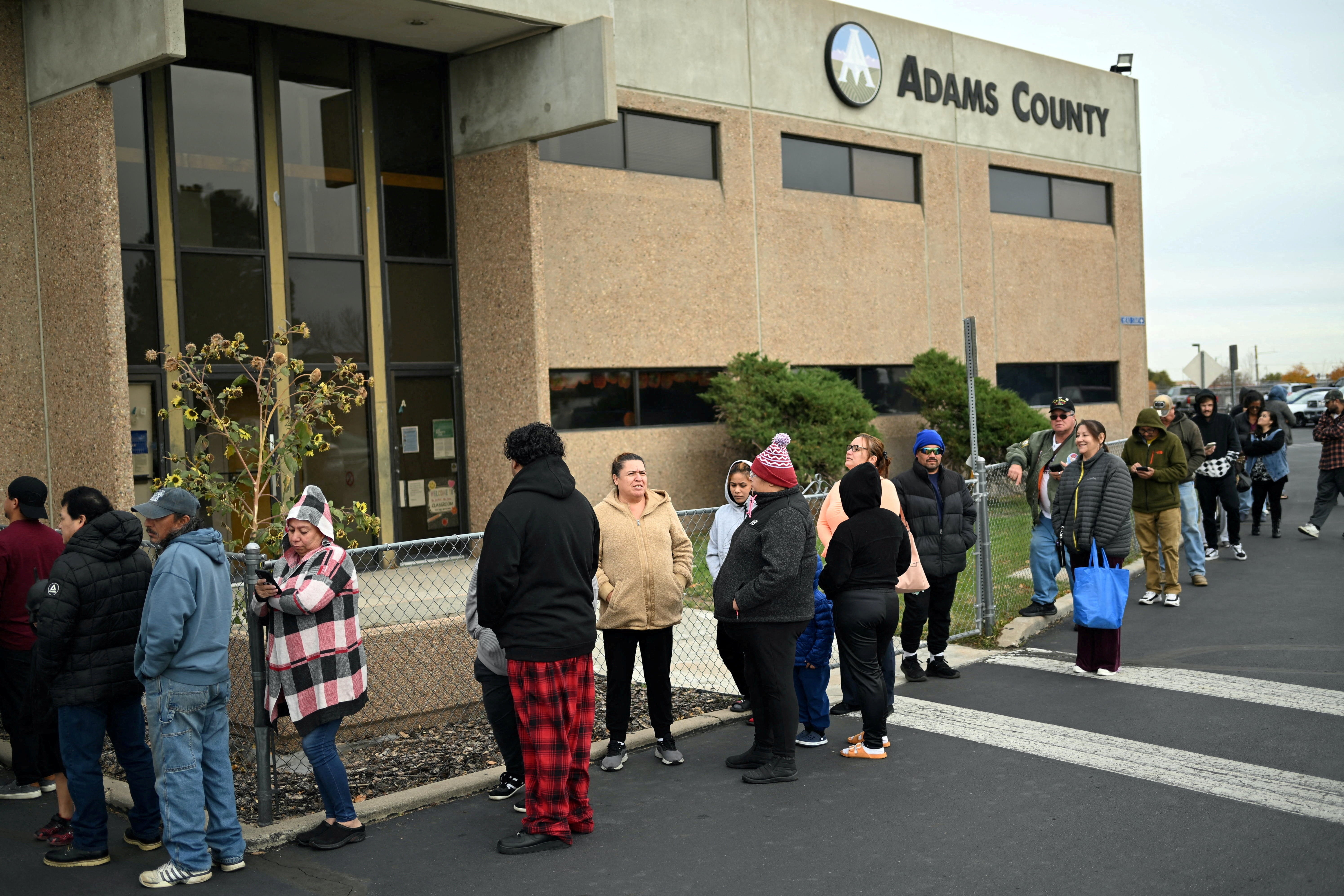 People wait in line at a food bank as federal workers go without pay for more than a month and uncertainty reigns about when millions of Americans will get full food stamp benefits due to the shutdown