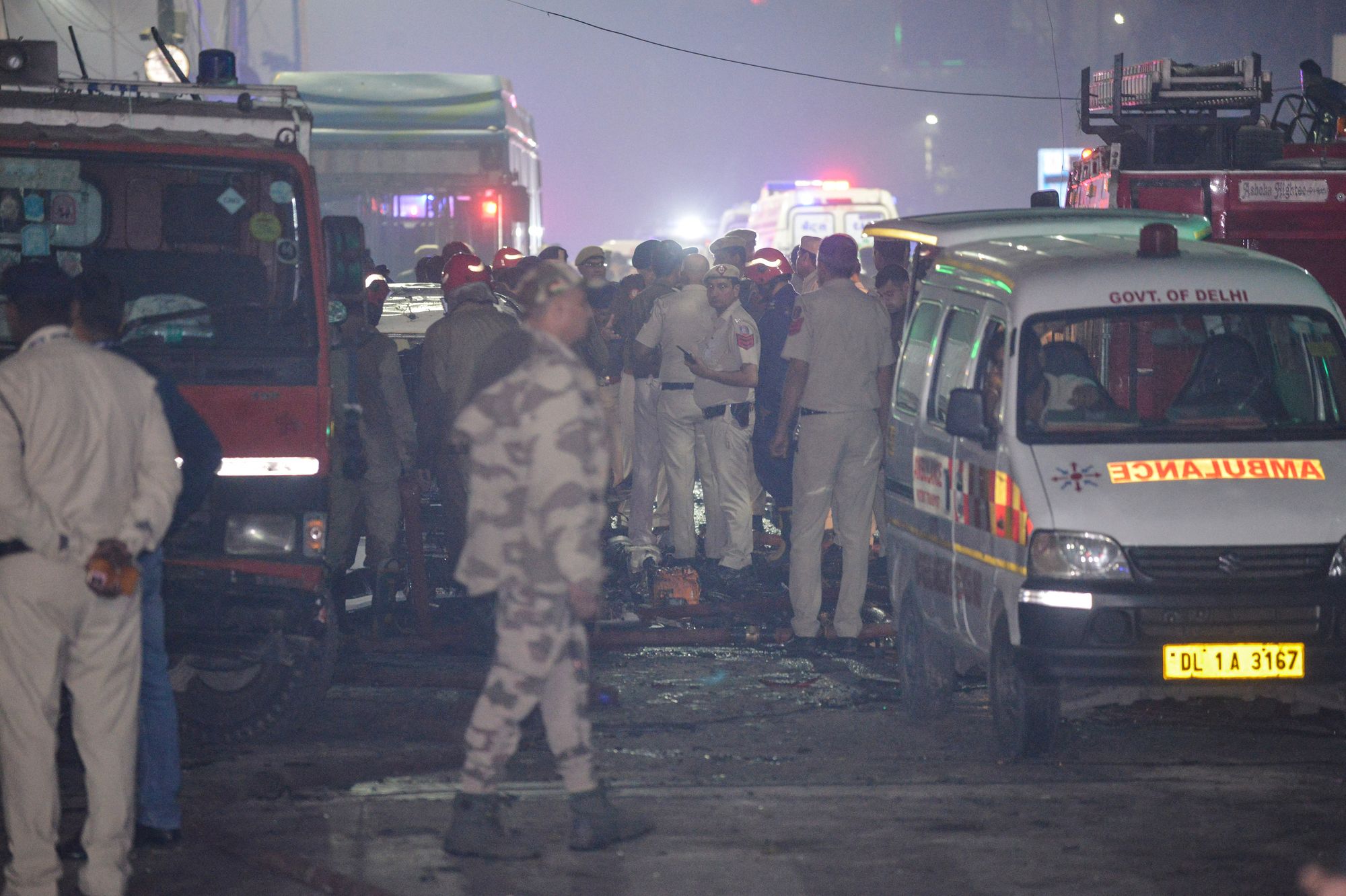 <p>Security personnel gather beside an ambulance at the blast site in Delhi</p>