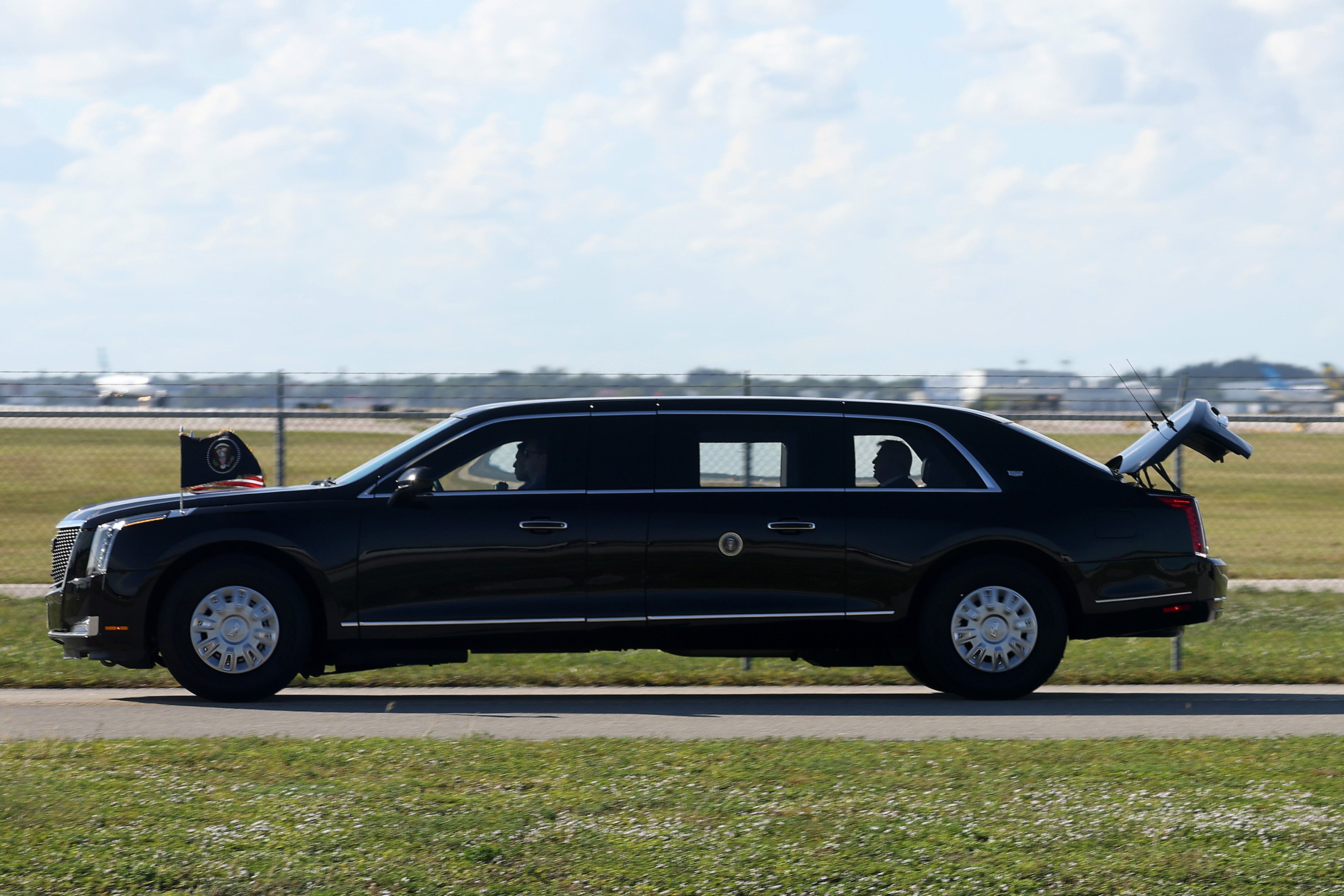 <p>President Donald Trump is driven in his limousine, "The Beast," with the trunk open on November 9, 2025 at Palm Beach International Airport in West Palm Beach, Florida</p>