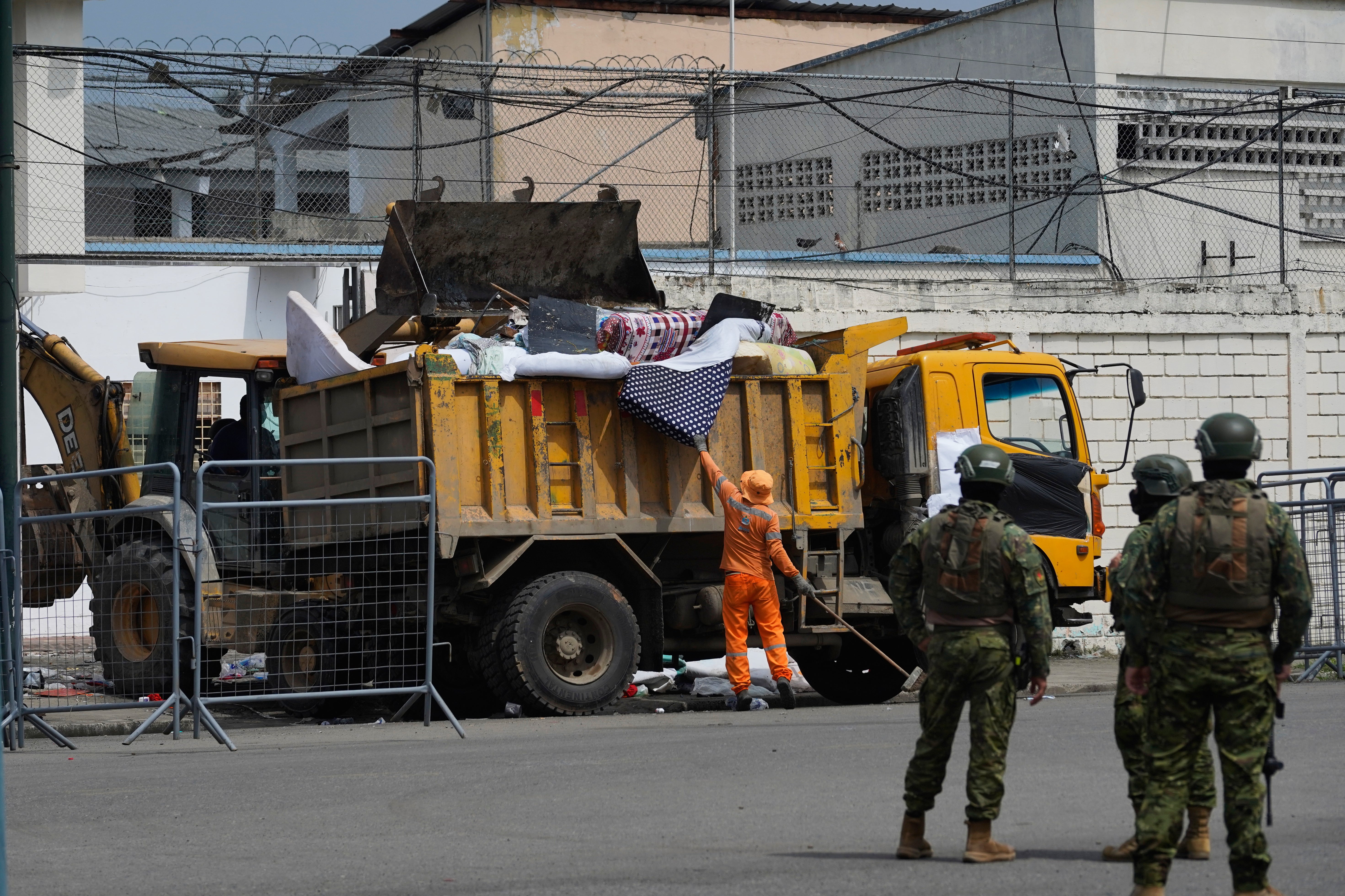 Ecuador Workers remove belongings from the prison where inmates were killed during clashes