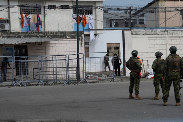 <p>Soldiers stand guard outside the prison where inmates were killed during clashes between themselves in Machala, Ecuador </p>