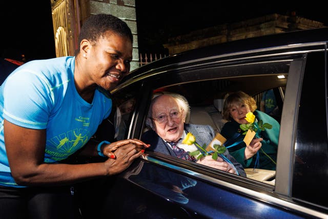President Michael D Higgins is gifted a flower whilst leaving Aras an Uachtarain with his wife Sabina Higgins (Damien Eagers/PA)